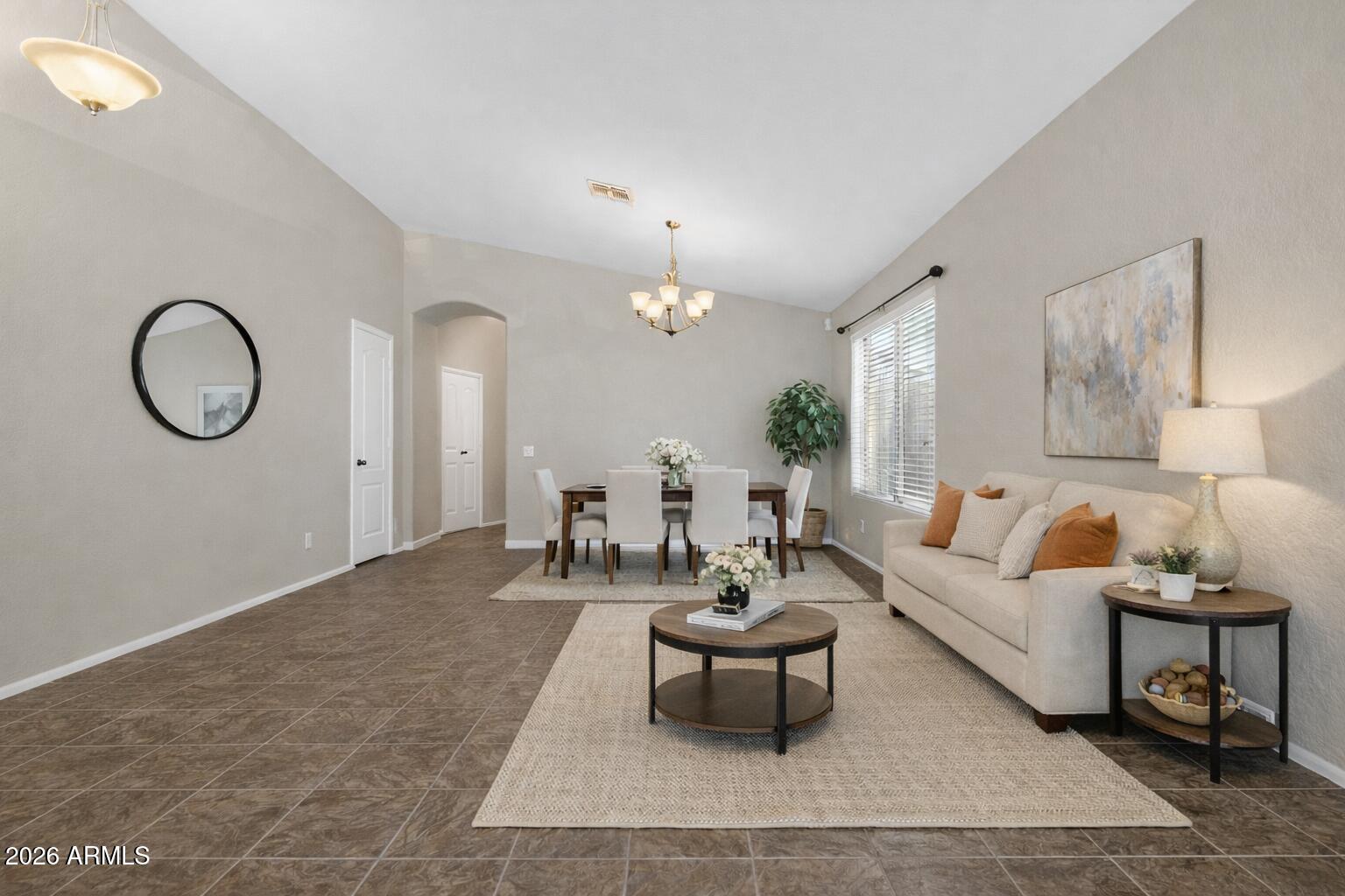 515 West Love Road San Tan Valley, AZ 85143 - Photo 5 of 74 a living room with furniture a chandelier and a rug
