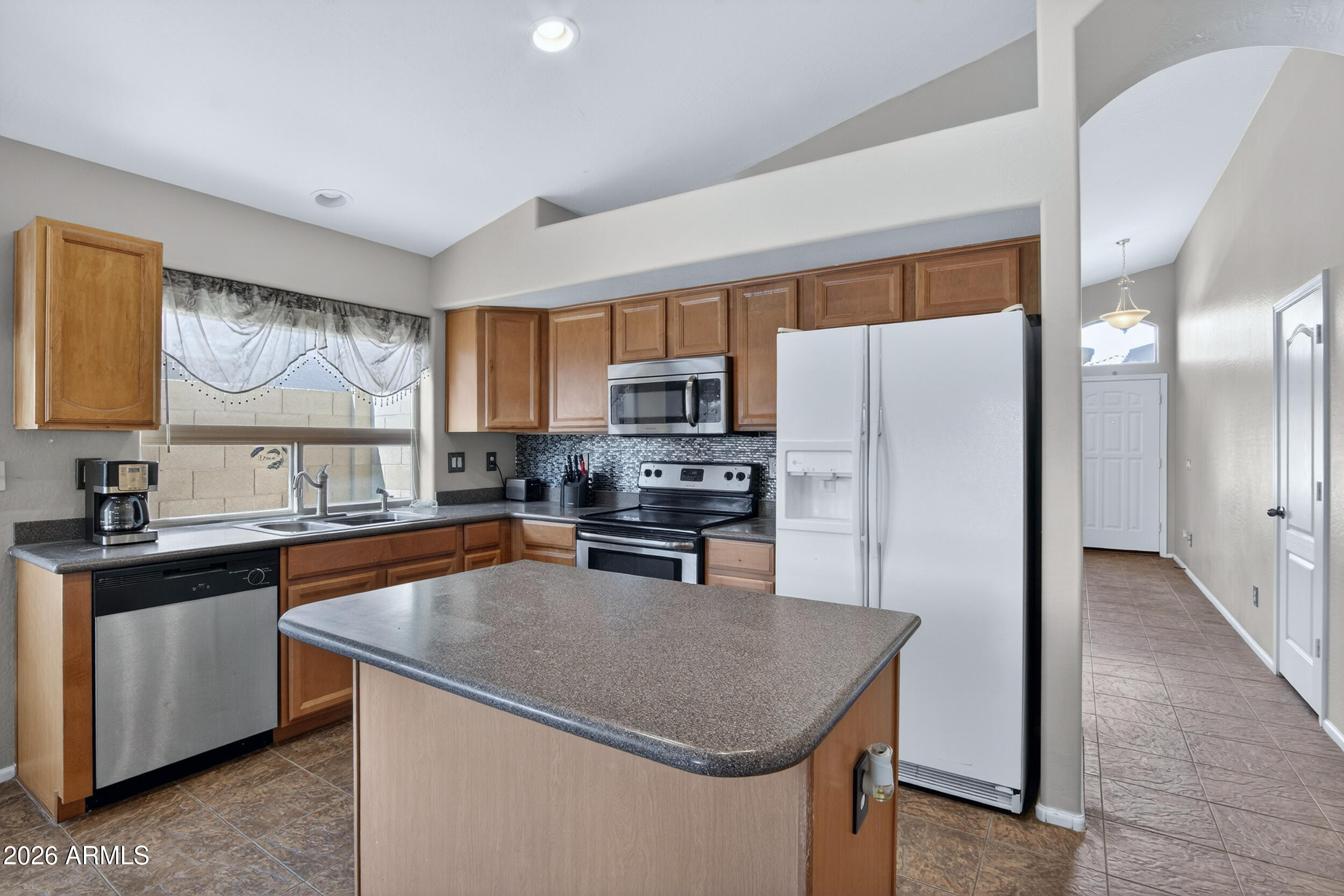 515 West Love Road San Tan Valley, AZ 85143 - Photo 8 of 74 a kitchen with stainless steel appliances granite countertop a refrigerator a stove top oven a sink and dishwasher