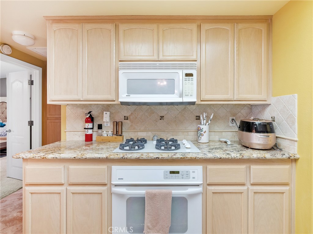 39429 Mountain View Road Yermo, CA 92398 - Photo 20 of 47 a kitchen with granite countertop a sink and cabinets