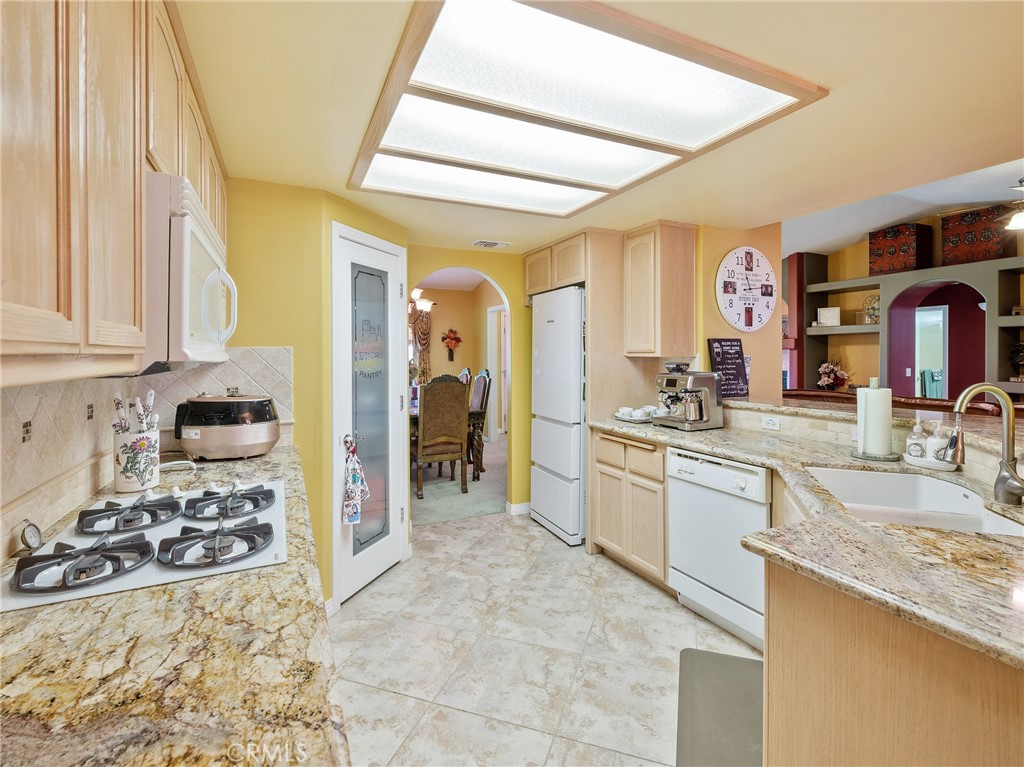 39429 Mountain View Road Yermo, CA 92398 - Photo 21 of 47 a large kitchen with kitchen island granite countertop a sink and cabinets