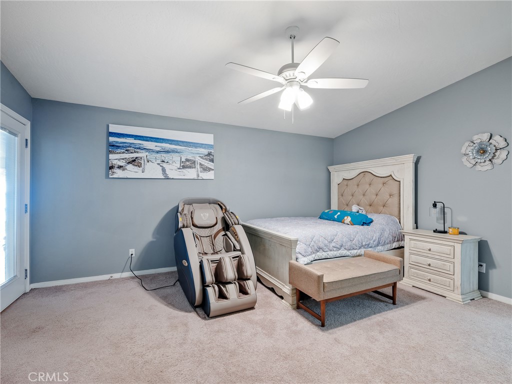 39429 Mountain View Road Yermo, CA 92398 - Photo 24 of 47 a bedroom with a bed and a chandelier