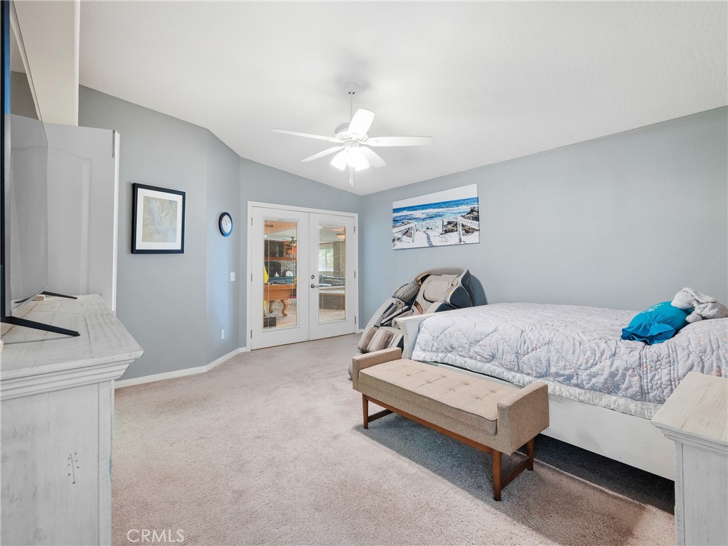 39429 Mountain View Road Yermo, CA 92398 - Photo 26 of 47 a bedroom with a bed and a chandelier