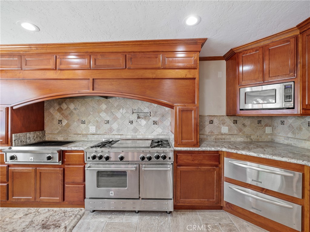 39429 Mountain View Road Yermo, CA 92398 - Photo 36 of 47 a kitchen with stainless steel appliances granite countertop a stove and a microwave