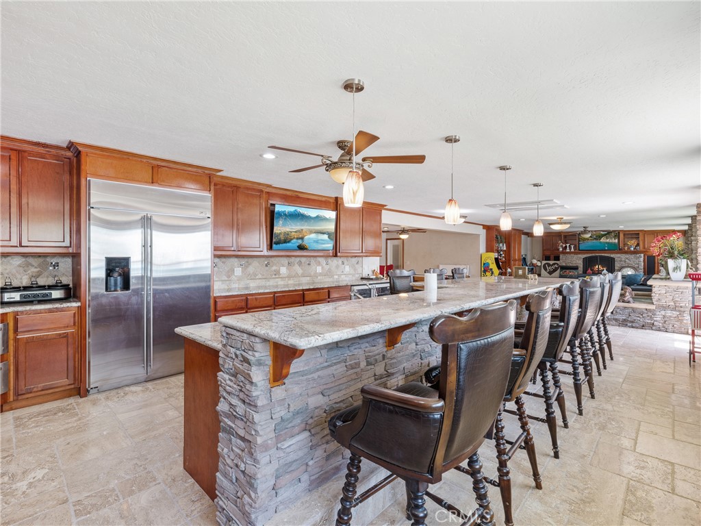 39429 Mountain View Road Yermo, CA 92398 - Photo 38 of 47 a kitchen with stainless steel appliances kitchen island granite countertop a table chairs sink and cabinets