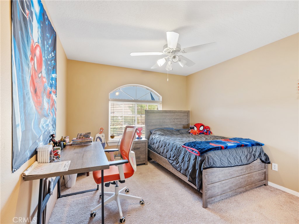 39429 Mountain View Road Yermo, CA 92398 - Photo 43 of 47 a bedroom with a bed and a chandelier