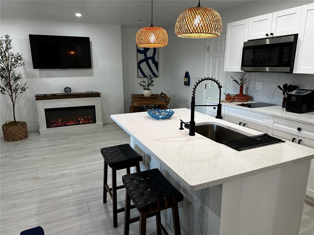 501 Pameto Road Nokomis, FL 34275 - Photo 30 of 37 a kitchen with a sink a microwave and cabinets