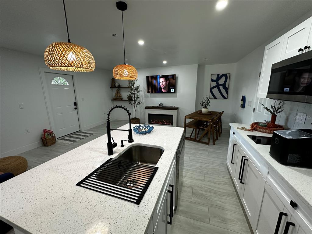 501 Pameto Road Nokomis, FL 34275 - Photo 33 of 37 a kitchen with a stove and a chandelier