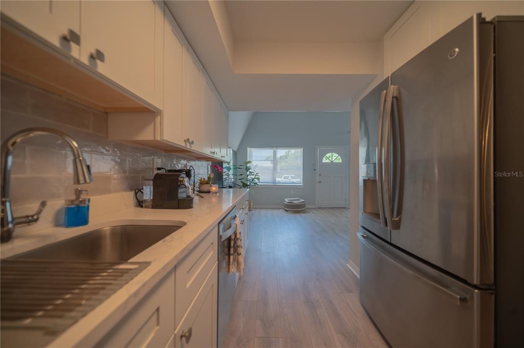 501 Pameto Road Nokomis, FL 34275 - Photo 7 of 37 a kitchen with stainless steel appliances granite countertop a refrigerator a sink and a stove