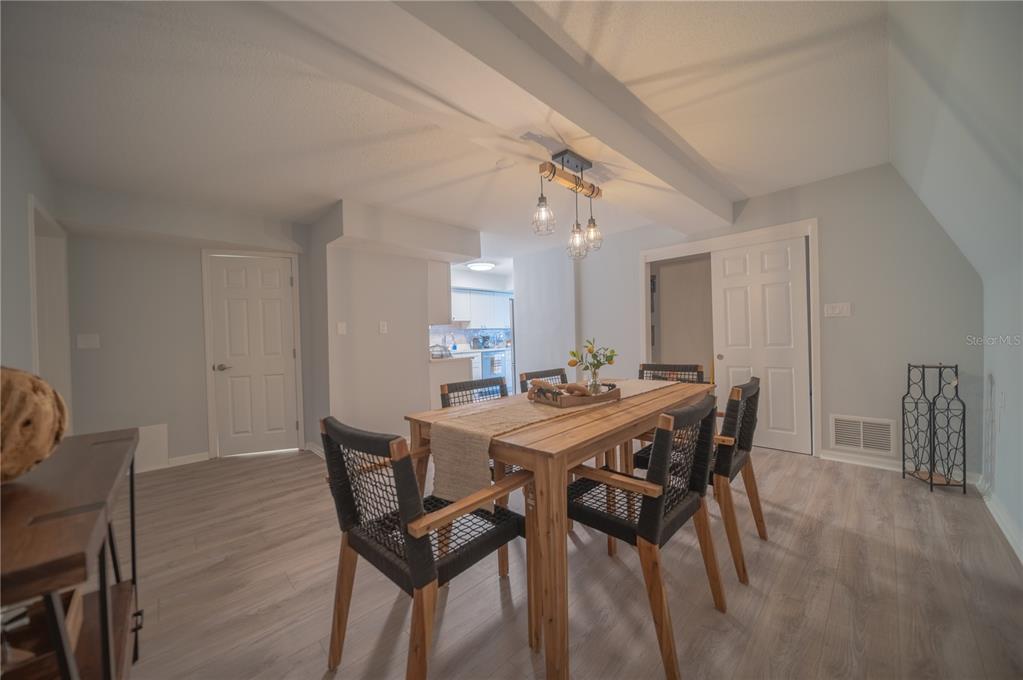 501 Pameto Road Nokomis, FL 34275 - Photo 9 of 37 a view of a dining room with furniture and wooden floor