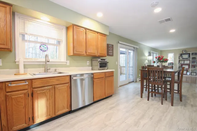 a kitchen with granite countertop a sink cabinets and window