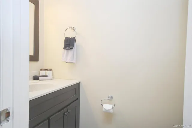 a bathroom with a sink vanity and mirror