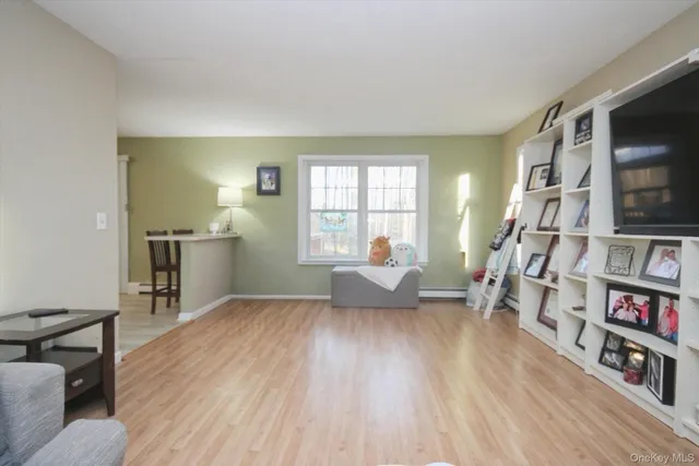 a living room with furniture and a book shelf