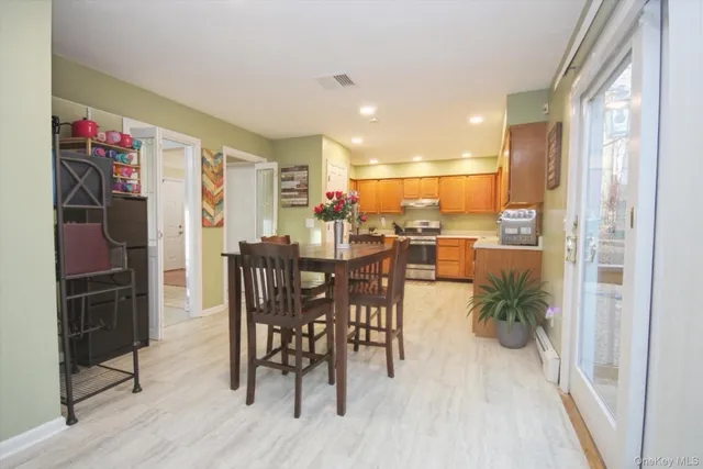 a view of a dining room with furniture window and wooden floor