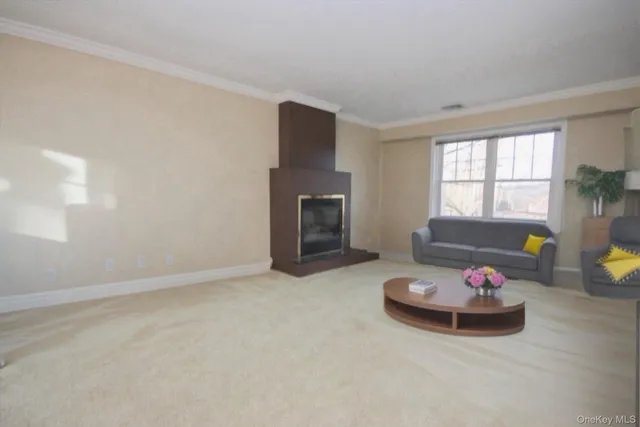 a living room with furniture a flat screen tv and a window