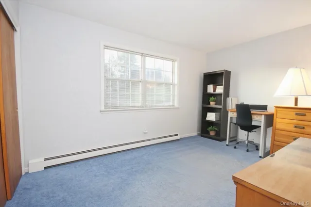 an empty room with furniture and windows