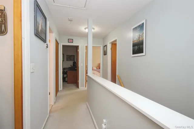 a view of a hallway with wooden shelves