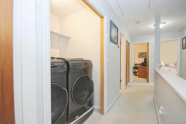 a view of a hallway with washer and dryer