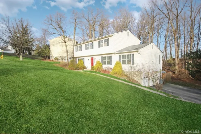 a front view of house with yard and green space
