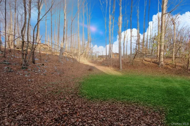 a view of a backyard with white fence