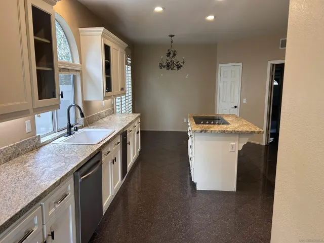 a bathroom with a granite countertop sink a toilet and a mirror