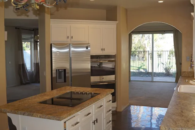 a kitchen with a refrigerator and a sink