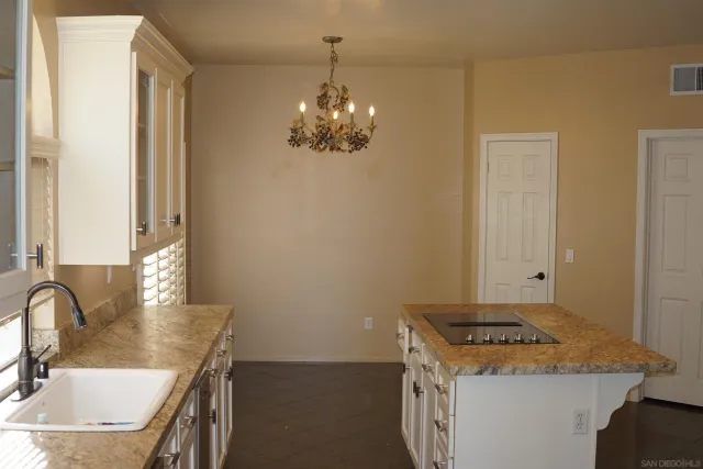 a kitchen with a sink a stove and a refrigerator