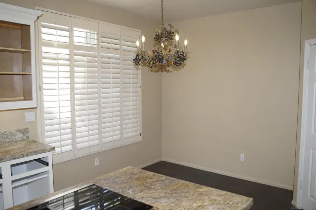 a view of a room with a window and a chandelier