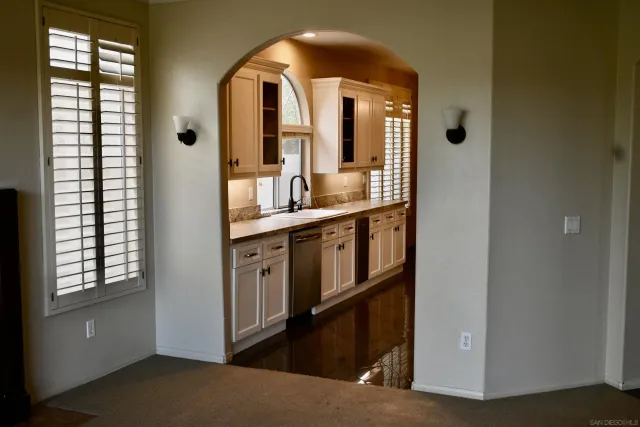a view of en suite bathroom with a sink and mirror