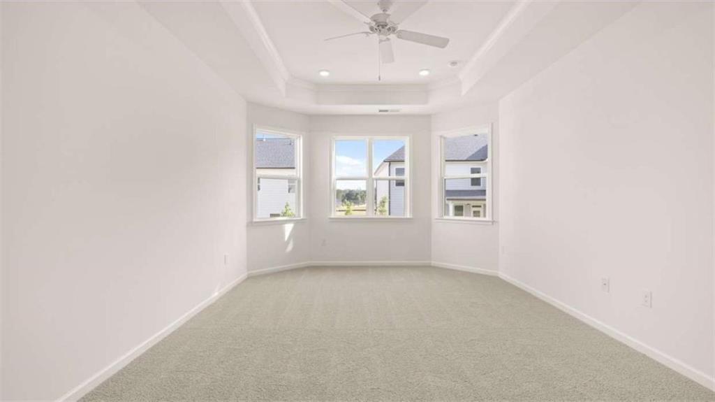 13623 Whitman Lane Covington, GA 30014 - Photo 17 of 45 an empty room with windows and chandelier fan