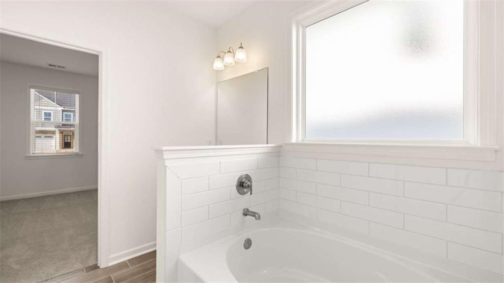 13623 Whitman Lane Covington, GA 30014 - Photo 22 of 45 a bathroom with bathtub and shower