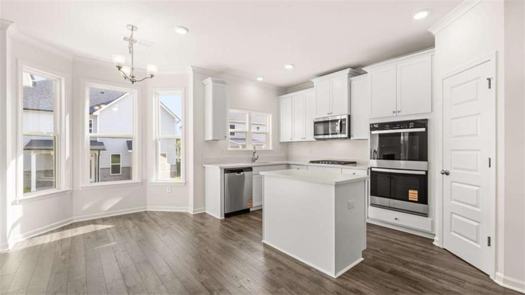 13623 Whitman Lane Covington, GA 30014 - Photo 4 of 45 a kitchen with stainless steel appliances a stove a sink and a refrigerator