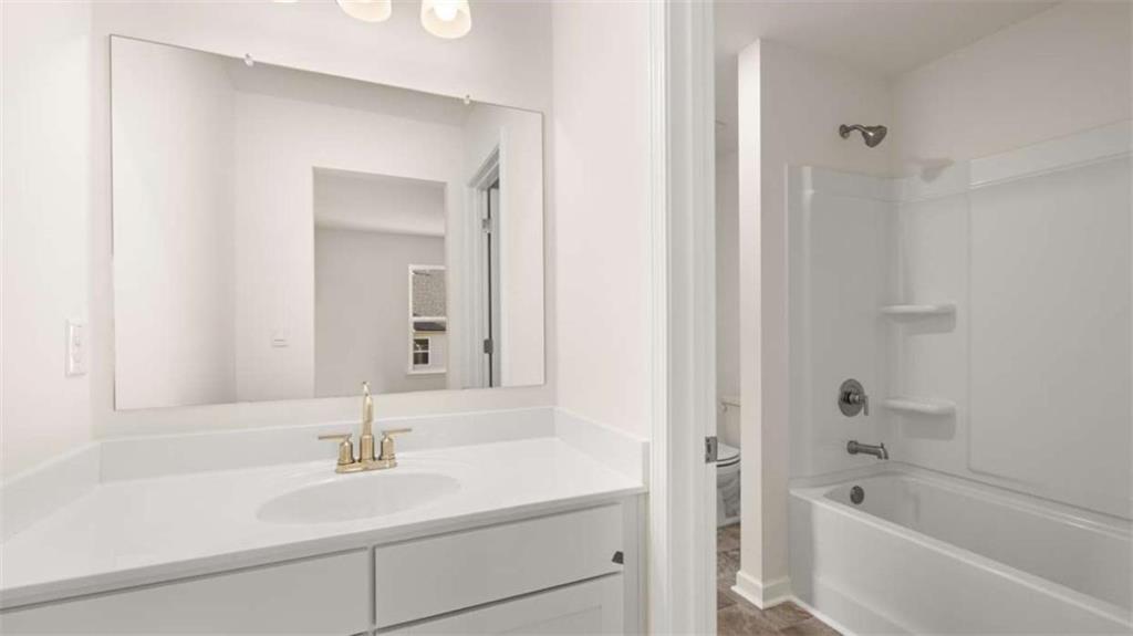 13623 Whitman Lane Covington, GA 30014 - Photo 41 of 45 a bathroom with a bathtub a sink and a mirror