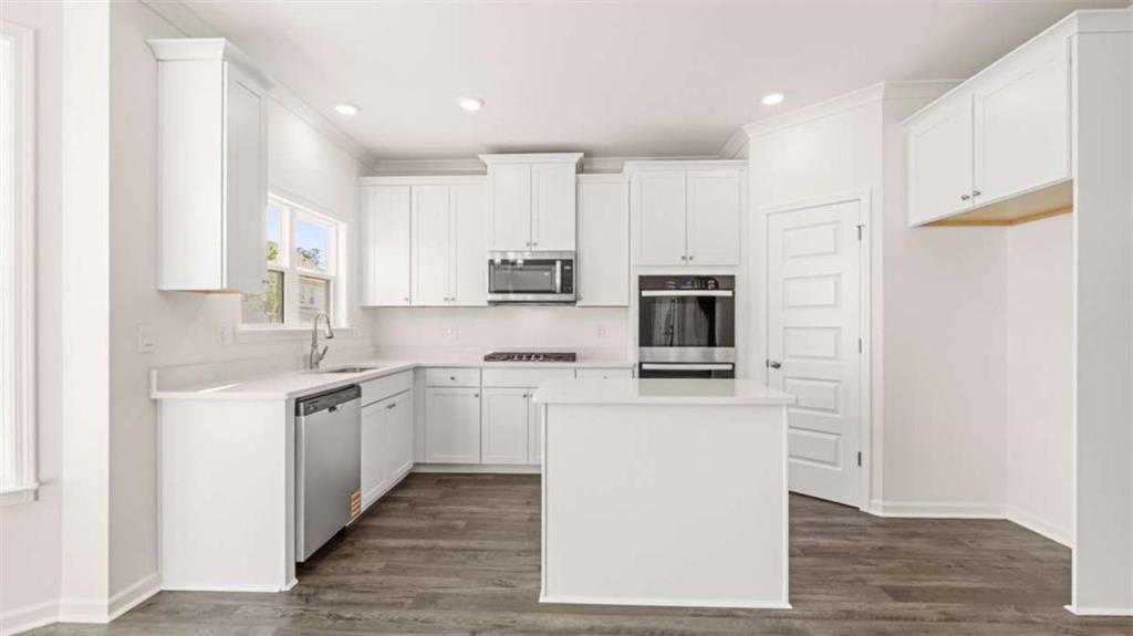 13623 Whitman Lane Covington, GA 30014 - Photo 5 of 45 a kitchen with stainless steel appliances granite countertop a stove top oven a sink and a refrigerator