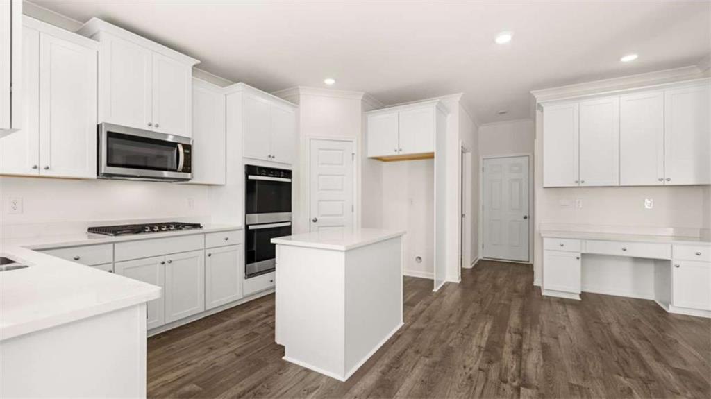 13623 Whitman Lane Covington, GA 30014 - Photo 8 of 45 a kitchen with cabinets stainless steel appliances and wooden floor