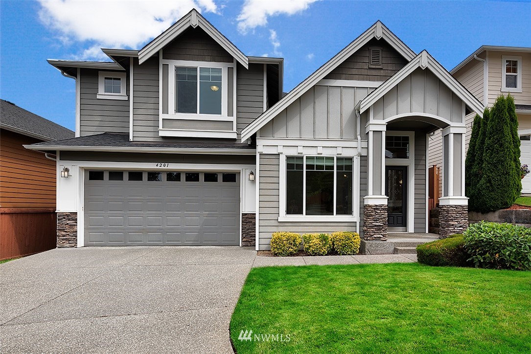 4201 222nd Place Southeast Bothell, WA 98021 - Photo 1 of 25 a front view of a house with a yard and garage