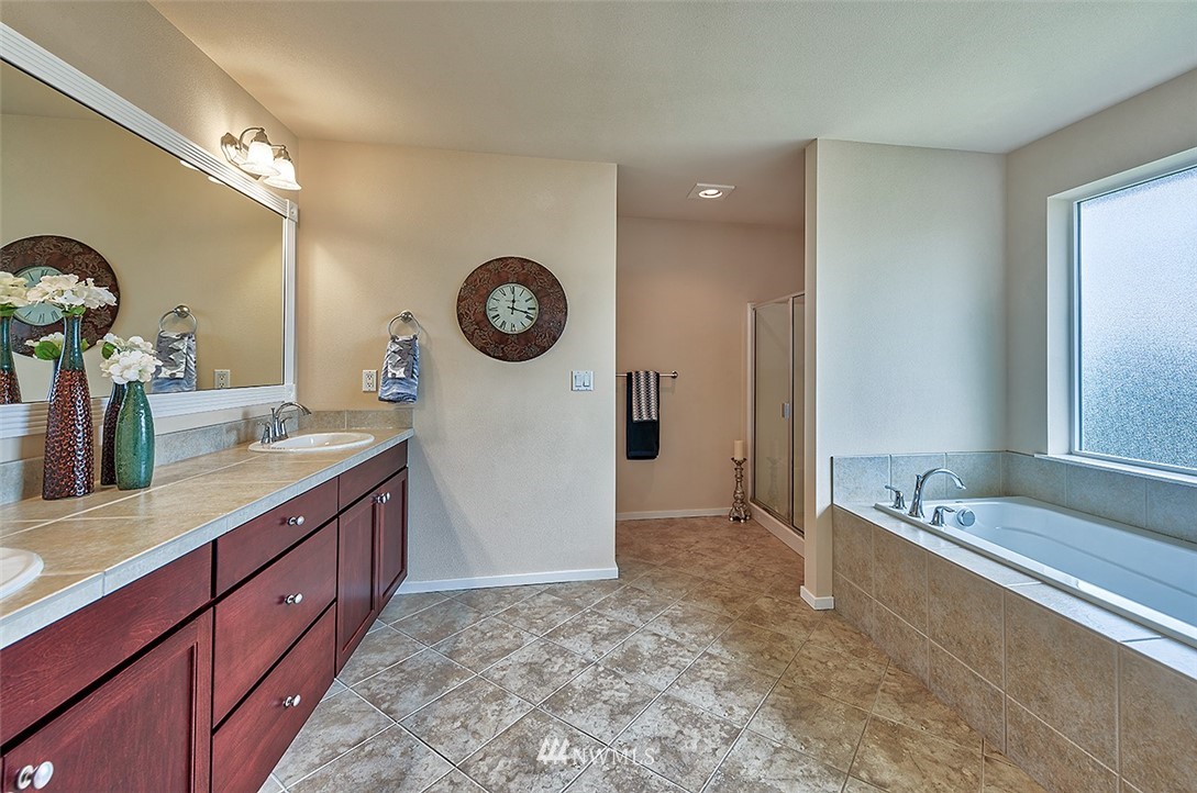 4201 222nd Place Southeast Bothell, WA 98021 - Photo 16 of 25 a spacious bathroom with a granite countertop sink and a mirror
