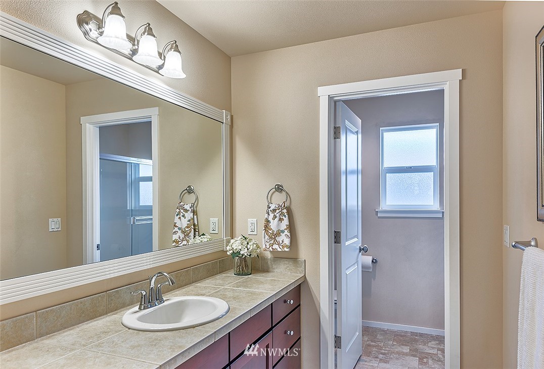 4201 222nd Place Southeast Bothell, WA 98021 - Photo 19 of 25 a bathroom with a sink and a mirror
