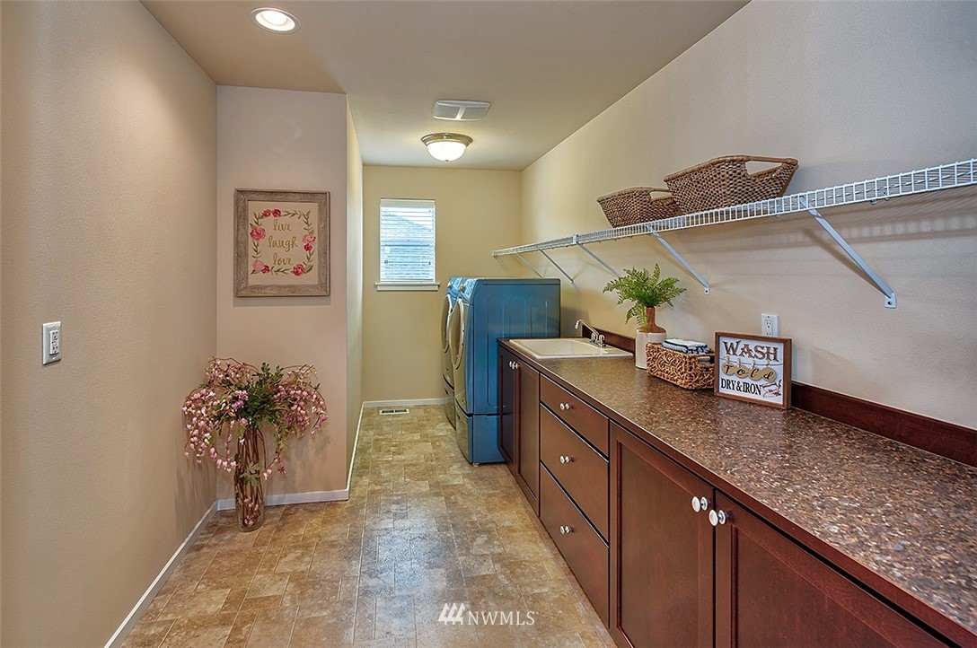 4201 222nd Place Southeast Bothell, WA 98021 - Photo 20 of 25 a kitchen with granite countertop a sink and cabinets