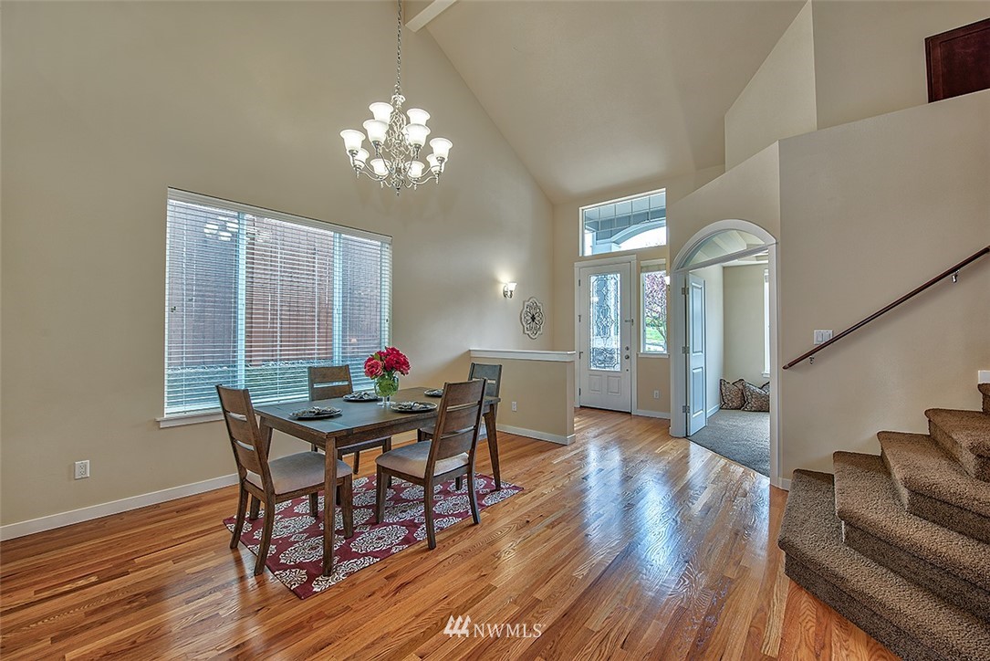 4201 222nd Place Southeast Bothell, WA 98021 - Photo 4 of 25 a view of a dining room with furniture a chandelier and wooden floor