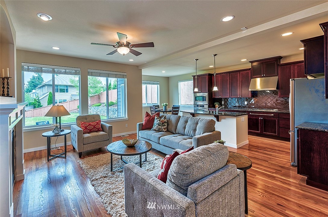 4201 222nd Place Southeast Bothell, WA 98021 - Photo 9 of 25 a living room with fireplace furniture and a wooden floor