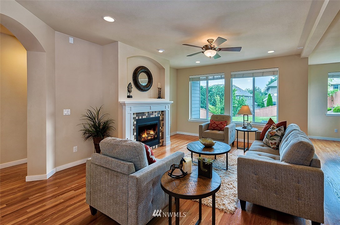 4201 222nd Place Southeast Bothell, WA 98021 - Photo 10 of 25 a living room with furniture a fireplace and a large window