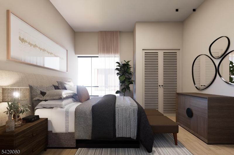 74 Webster Street Newark, NJ 07104 - Photo 20 of 22 a bed room with a bed and a potted plant