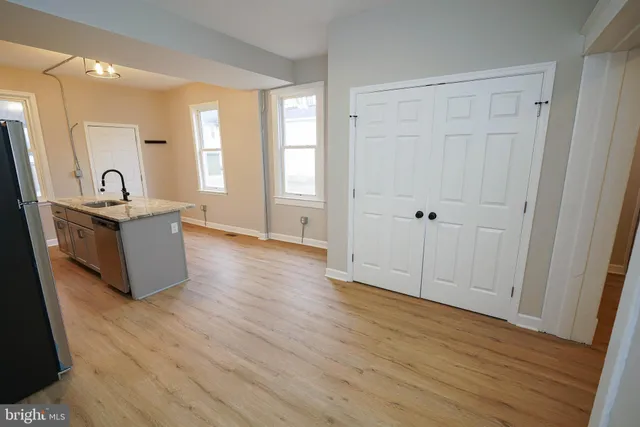 a living room with hard wood floors and a window