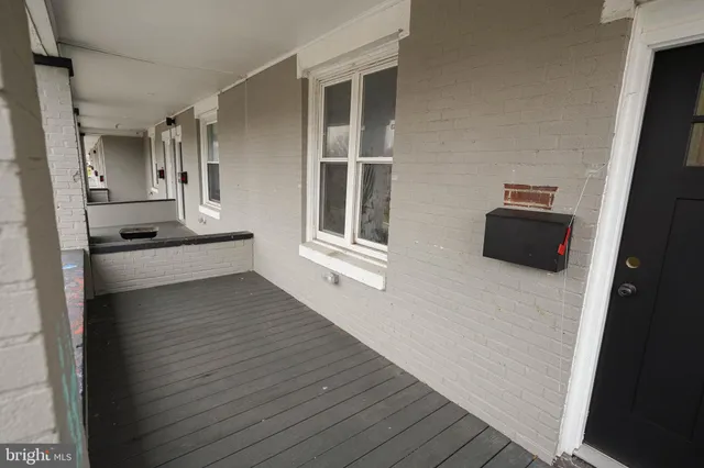 a view of a living room with furniture and wooden floor