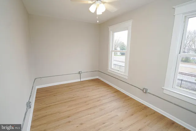 a room with wooden floor and white walls