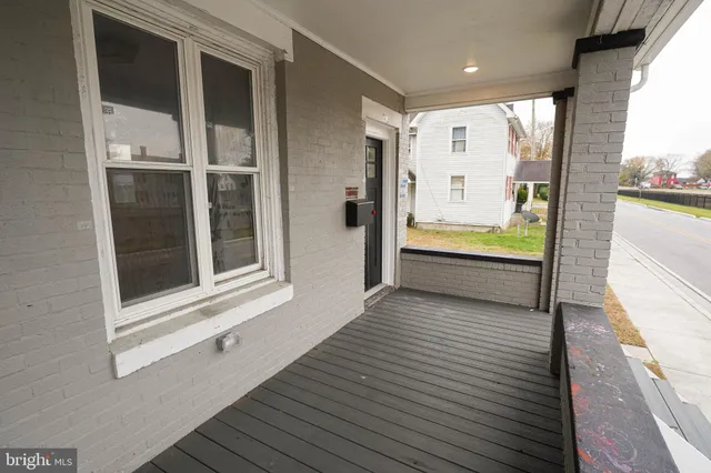 a view of a balcony with wooden floor and outer view