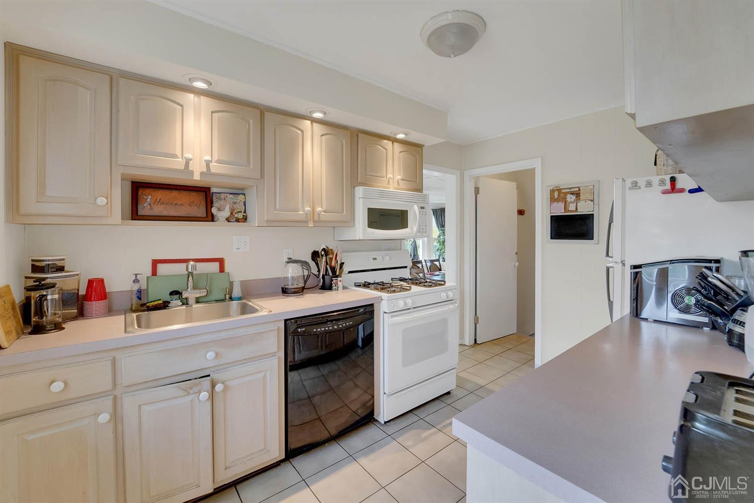 21 Villanova Road Old Bridge, NJ 08859 - Photo 2 of 15 a kitchen with a sink stove and refrigerator