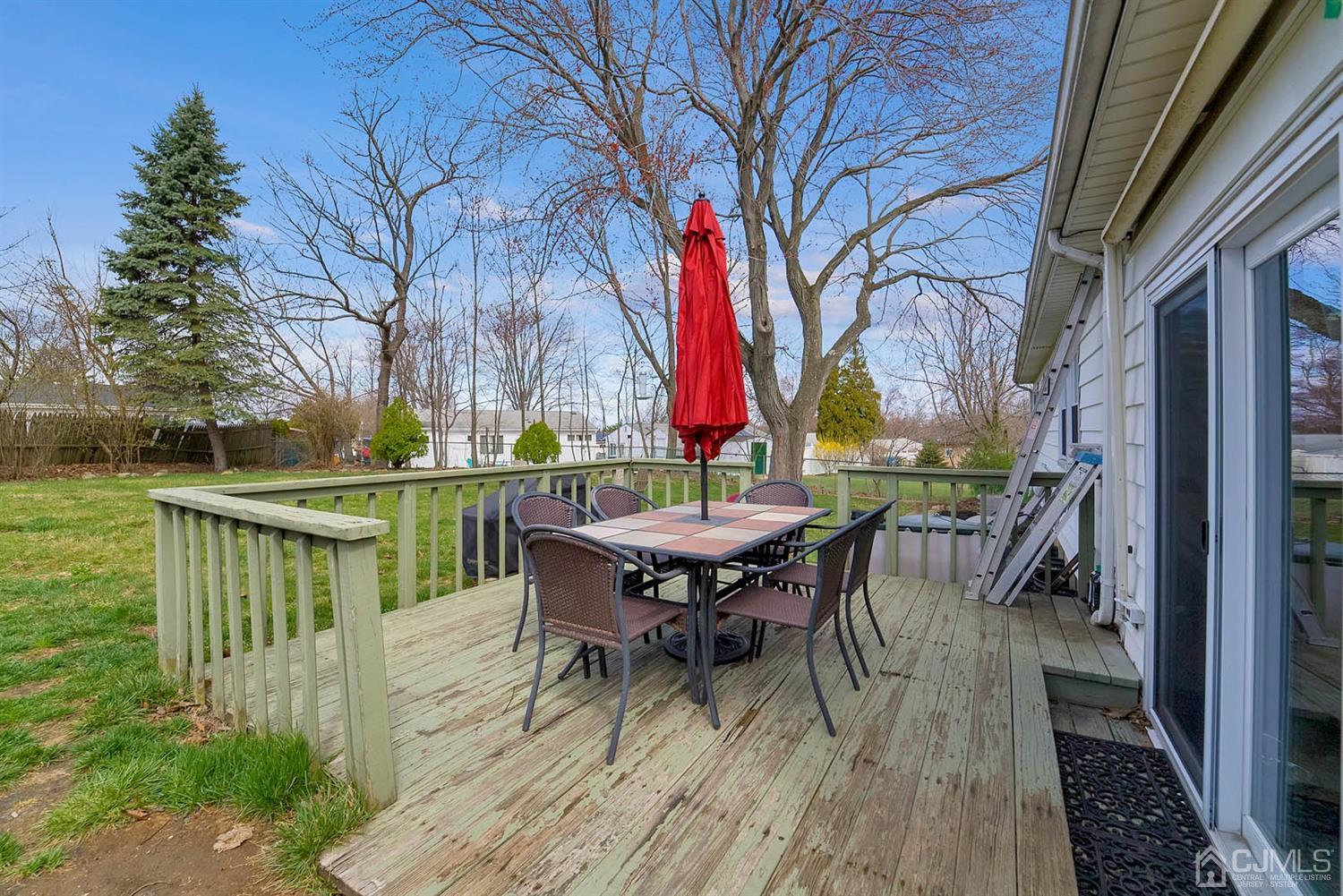 21 Villanova Road Old Bridge, NJ 08859 - Photo 13 of 15 a backyard of a house with wooden floor table and chairs
