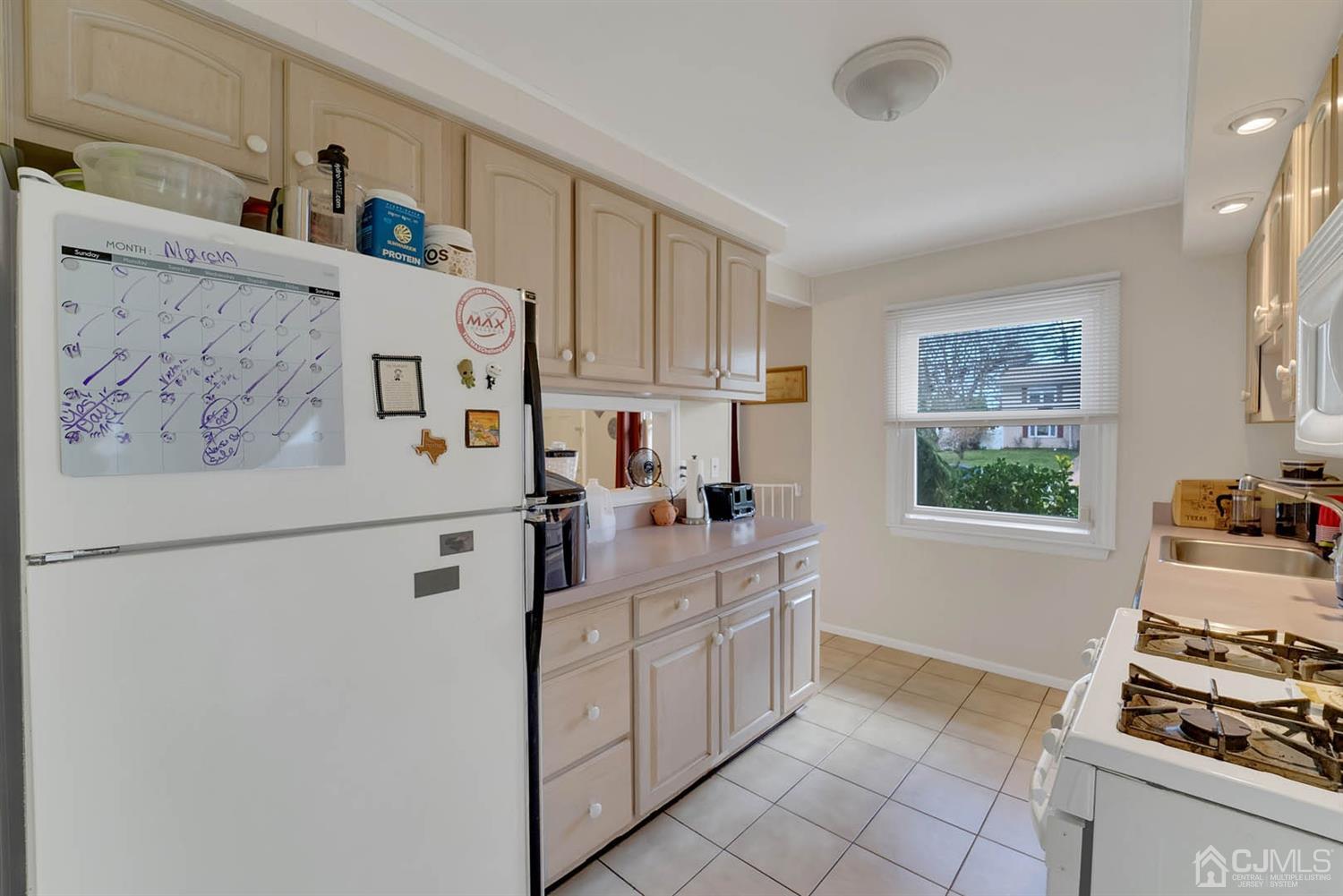 21 Villanova Road Old Bridge, NJ 08859 - Photo 3 of 15 a kitchen with white cabinets and white appliances
