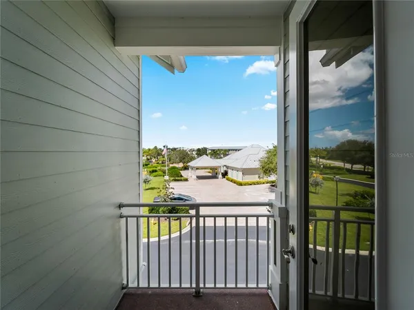 an aerial view of a house with outdoor space and lake view in back yard